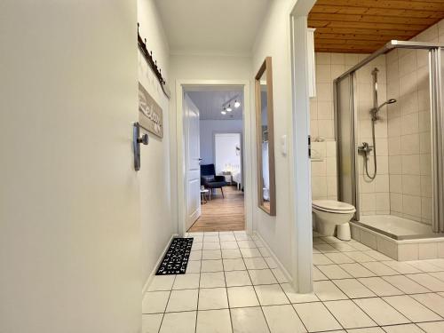 y baño con ducha a ras de suelo y aseo. en Gästehaus am Kampland - Wohnung 4 en Dahme