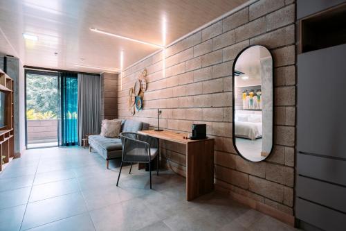 a living room with a brick wall and a mirror at Hotel Living by Armoniko in Medellín