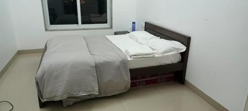 a bed with two pillows on it in a room at URBAN NEST's BY VEGA SPACES in Belgaum