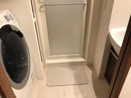 a washing machine in a bathroom next to a sink at Local Hakata apartment No5 in Fukuoka