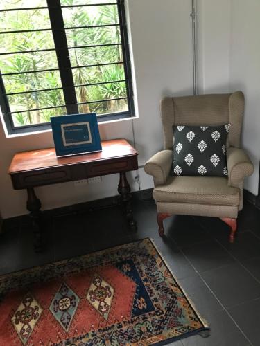 a laptop sitting on a desk next to a chair at BAA BAA RESIDENCE in Hillcrest