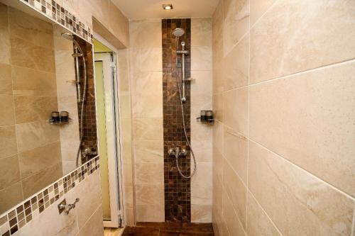 a bathroom with a shower with a glass door at Charming loft, very good located! in Sofia