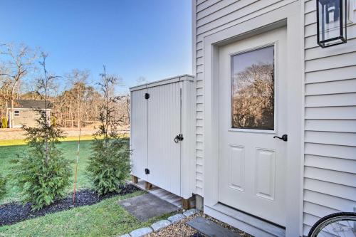 a white door on the side of a house at Modern Apt Near Marthas Vineyard Beaches! in Oak Bluffs