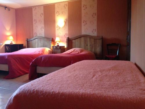 a hotel room with two beds and two chairs at Gite de Fontepaisse in Saint-Jean-en-Royans