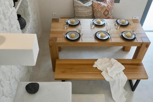 a wooden table with plates of food on it at M&D Stories in Pirgos