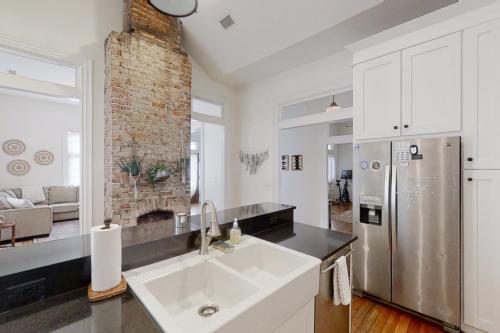 a kitchen with a sink and a refrigerator at Woodland Wonder in Nashville