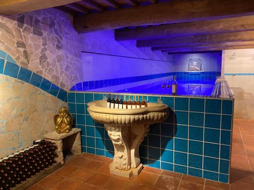 a bathroom with a sink in a room with blue tiles at I SEI FILARI in Capannori