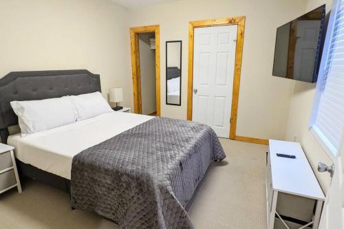 a bedroom with a large bed and a television at 3 Bedroom Hardwood Palace of Charleston in Charleston