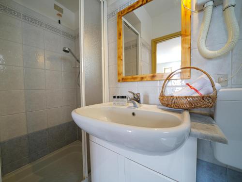 a bathroom with a sink and a mirror and a shower at Hotel Skilift - Dada Hotels in Frabosa Soprana