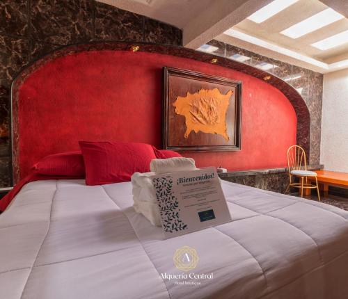 a bed with a red headboard with a sign on it at Alquería Central hotel in Tlaxco de Morelos