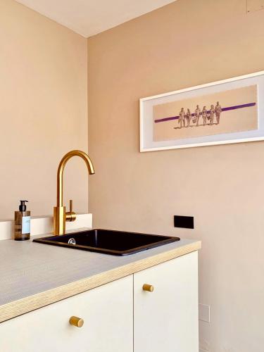 a kitchen with a black sink and a counter at Casita 10 Málaga, holiday home with roof terrace in Málaga