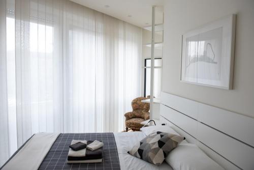 a bedroom with a bed and a chair at Il Vicolo in Como