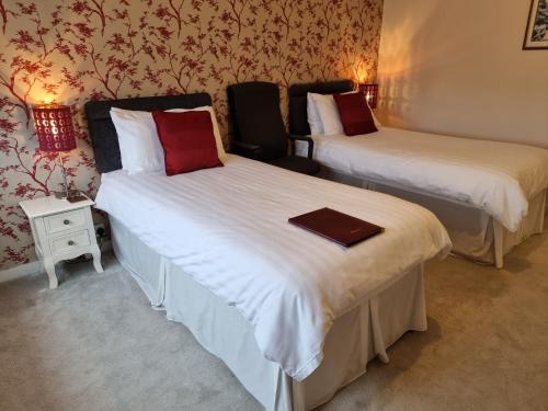 Katil atau katil-katil dalam bilik di Denham Guest House