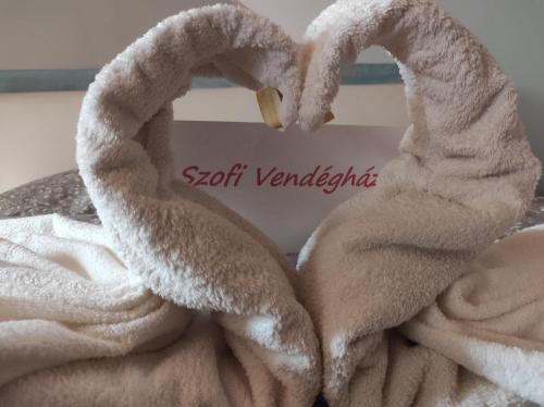 a towel with two swans making a heart at Szofi Vendégház in Kereki