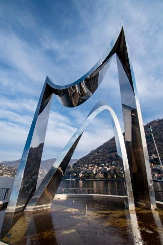 a large metal arch with a view of a city at Il Vicolo in Como
