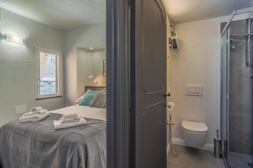 a bedroom with a bed and a shower and a toilet at Stella by PortofinoHomes in Portofino