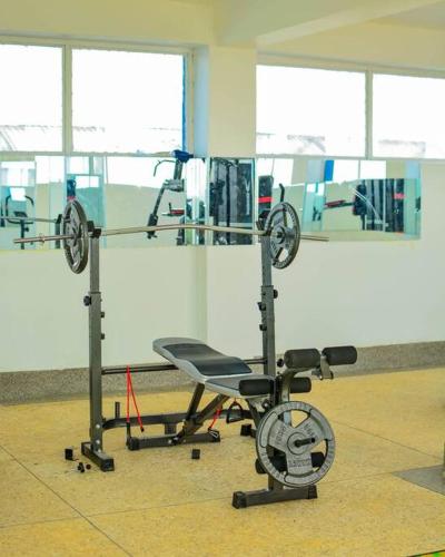 a gym room with a chair and a machine at Chloe One Bedroom in Nanyuki