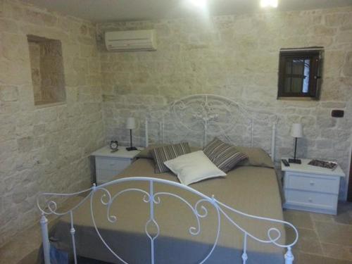 a bedroom with a bed with a white bed frame at B&B Fiano Marchione in Castellana Grotte