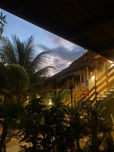 a view of a resort with palm trees and a building at Pousada Águas de Tamandaré in Tamandaré