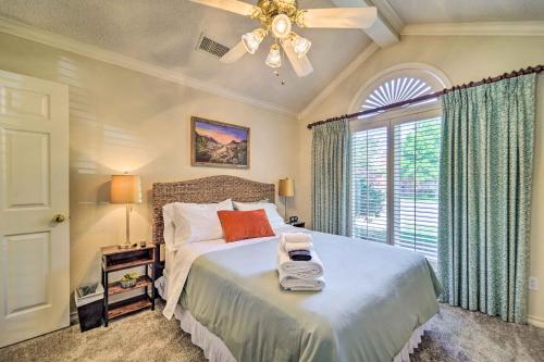 a bedroom with a bed with a ceiling fan and a window at Lubbock Home with Patio about 6 Mi to Texas Tech! in Lubbock