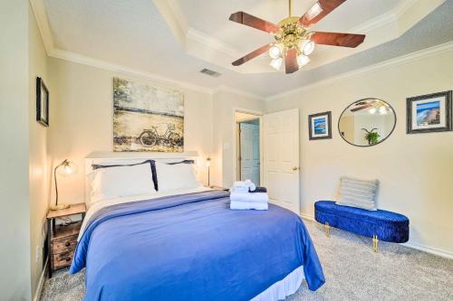 a bedroom with a blue bed and a ceiling fan at Lubbock Home with Patio about 6 Mi to Texas Tech! in Lubbock