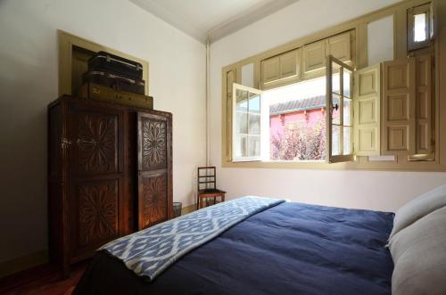a bedroom with a bed and a dresser and a window at CASA LUCRECIA in Santiago