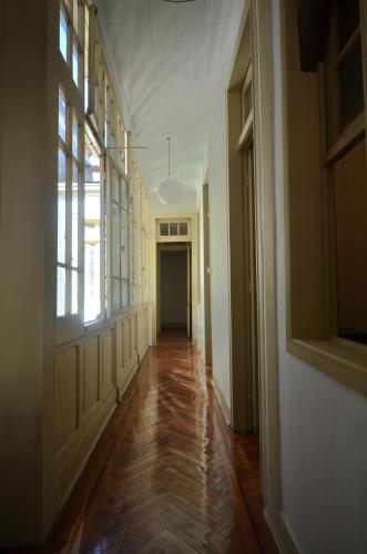 an empty hallway of a home with wood floors and windows at CASA LUCRECIA in Santiago
