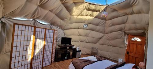 a room with a large tent with a bed in it at Club de Campo Alto Copiapó in Piedra Colgada