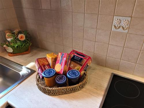 a basket of food on a counter in a kitchen at ZENIA Pelion garden house in Platanidia