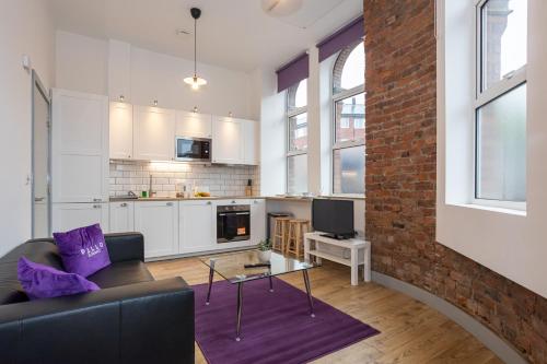 a living room with a couch and a table at Pillo Rooms Apartments - Salford in Manchester