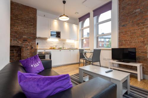 a living room with a couch and a table at Pillo Rooms Apartments - Salford in Manchester