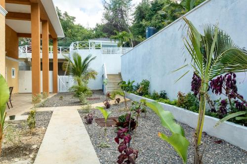 a garden in front of a house with plants at BayWatch Villa - Montego Bay in Montego Bay