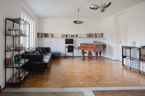 a living room with a couch and a piano at Zweitwohnsitz in Drosendorf Stadt