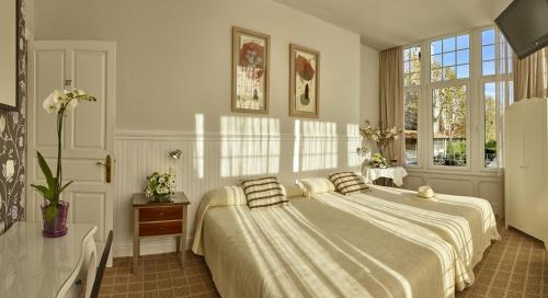a bedroom with a large bed with two pillows on it at Hotel Atalaya in Mundaka