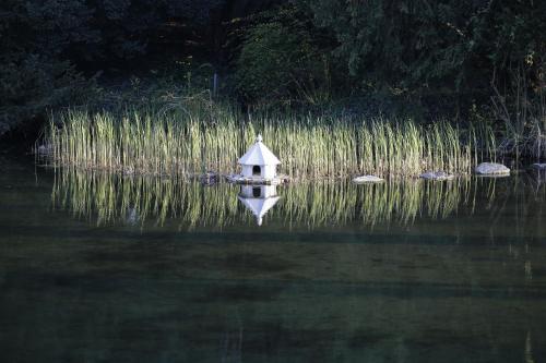 a small boat in the middle of a body of water at Schloss Schönau in Schönau an der Triesting