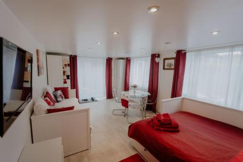 a bedroom with a red bed and a living room at Cannock Chase Guest House Self Catering incl all home amenities & private entrance in Cannock