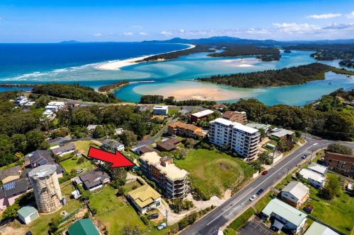 an aerial view of a resort property with the ocean at Karingal in Nambucca Heads