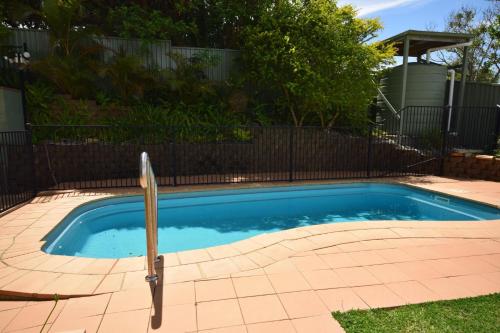 a small swimming pool in a yard with a fence at Karingal in Nambucca Heads