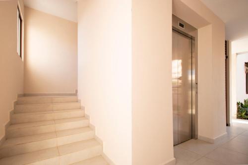 a staircase in a house with a glass door at Ambar Condominios Mazatlan in Mazatlán
