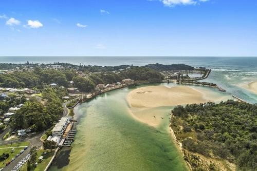an aerial view of a beach and the ocean at Quayside in Nambucca Heads
