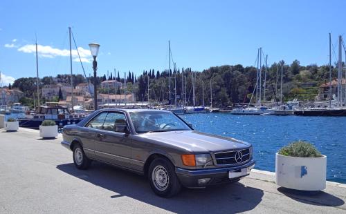 a car parked next to a marina with boats at Apartments Desirée in Sutivan