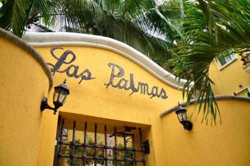 a yellow building with the words las palmas written on it at Las Palmas - Palma Xiat & Cocoyol in Playa del Carmen