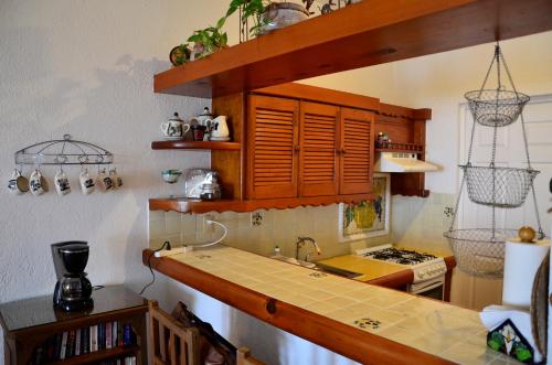 a kitchen with wooden cabinets and a counter top at Las Palmas - Palma Xiat & Cocoyol in Playa del Carmen