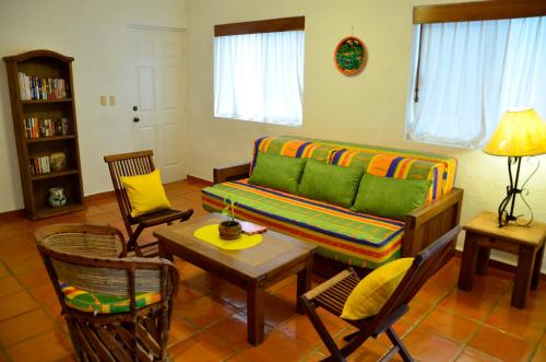 a living room with a couch and chairs and a table at Las Palmas - Palma Xiat & Cocoyol in Playa del Carmen