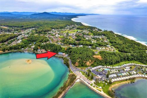 an aerial view of a beach with a red arrow at Estuary in Nambucca Heads