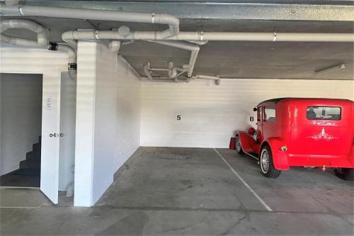 a garage with a red car parked in it at Estuary in Nambucca Heads