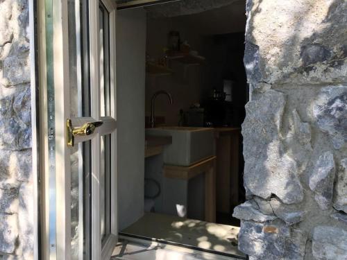an open door to a bathroom with a sink at Fermoyle Properties Glynn's Cottage in Fanore