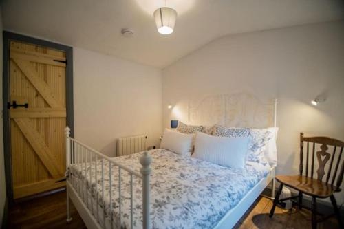 a bedroom with a bed and a wooden door at Glynn's Charming cottage in the Burren in Fanore