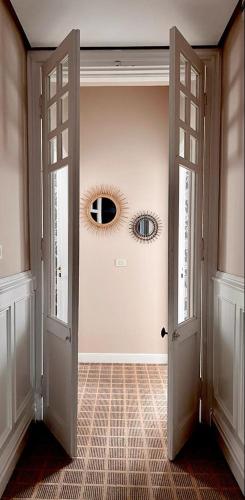a hallway with two doors and a mirror on the wall at Hotel Atalaya- FREE PARKING GRATUITO in Mundaka