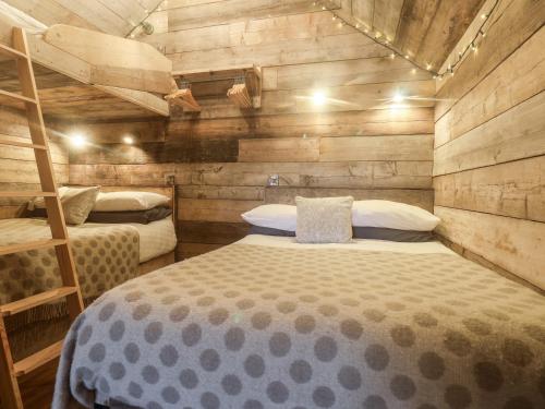 a bedroom with two bunk beds and a ladder at Foxes Den in Scarborough